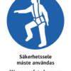 Påbudsskylt med symbol för säkerhetssele och texten "Säkerhetssele måste användas" samt engelsk text "Wear a safety harness".